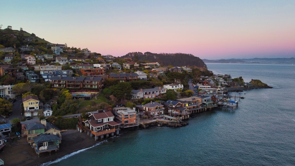 an aerial view of a city on a hill next to the ocean