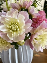 A close-up of a delicate floral arrangement in a simple vase.