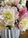 Close-up of an elegant flower arrangement in soft cream and pink tones.