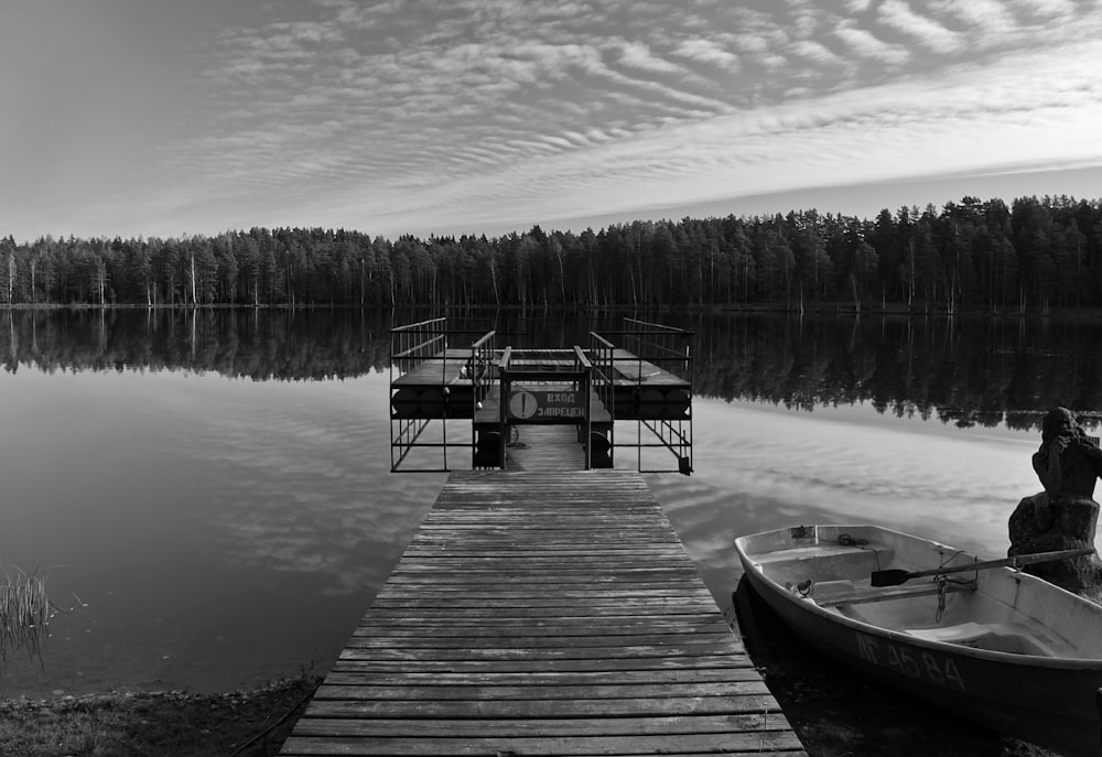 a man standing on a dock next to a boat