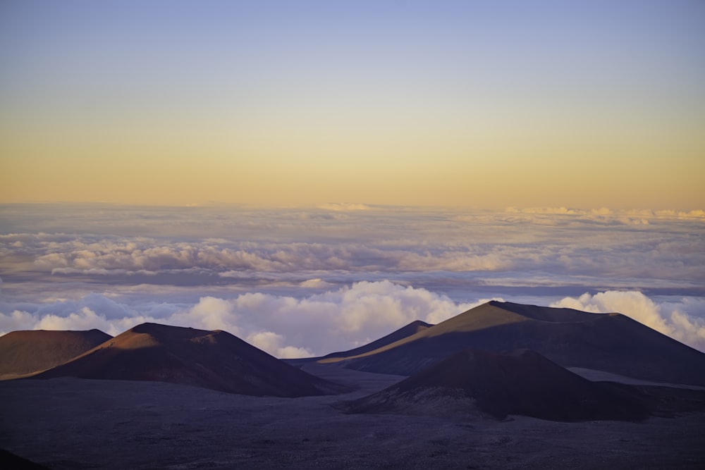 a group of mountains with clouds in the sky