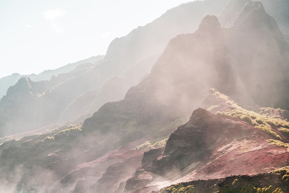 a view of a mountain range with steam rising from the ground