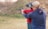 a man and a woman are aiming at a target