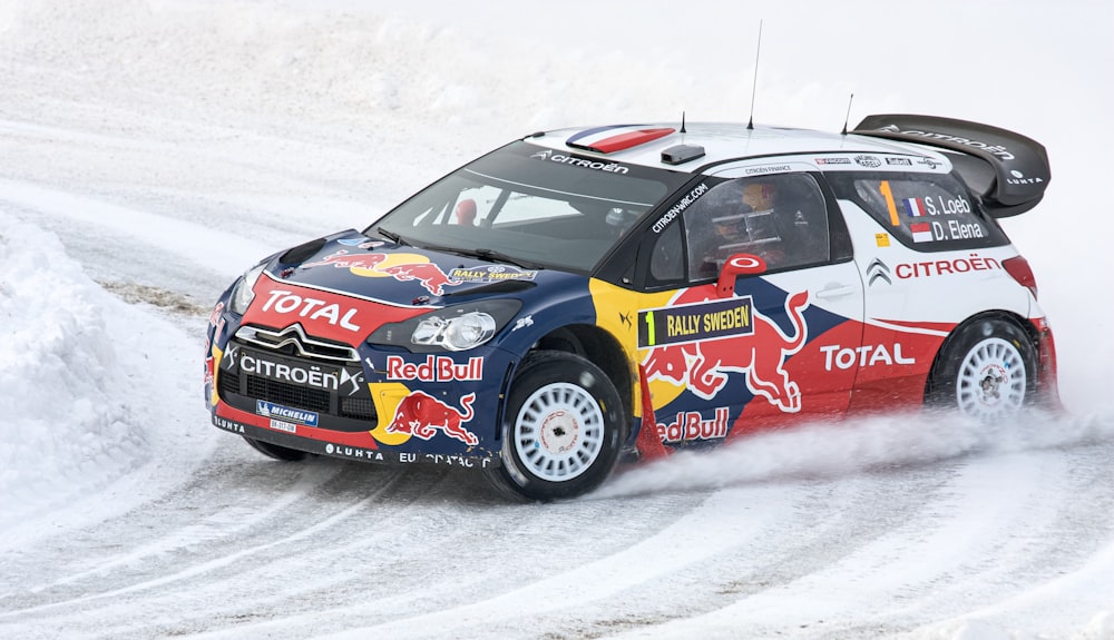 a rally car driving on a snowy road