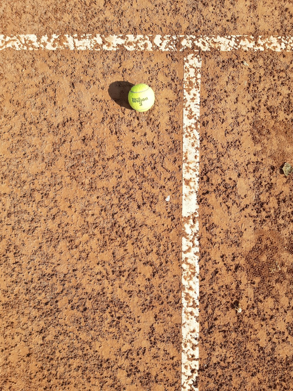 a tennis ball sitting on a tennis court