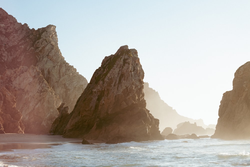 a view of the ocean with rocks in the background