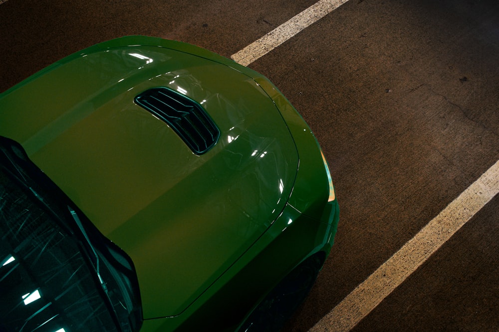 a green sports car parked in a parking lot