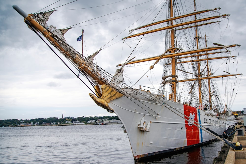 a large white ship docked at a pier