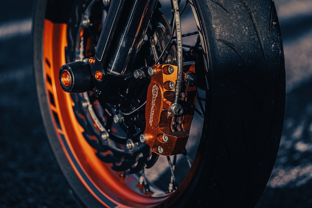 a close up of a motorcycle tire with orange rims