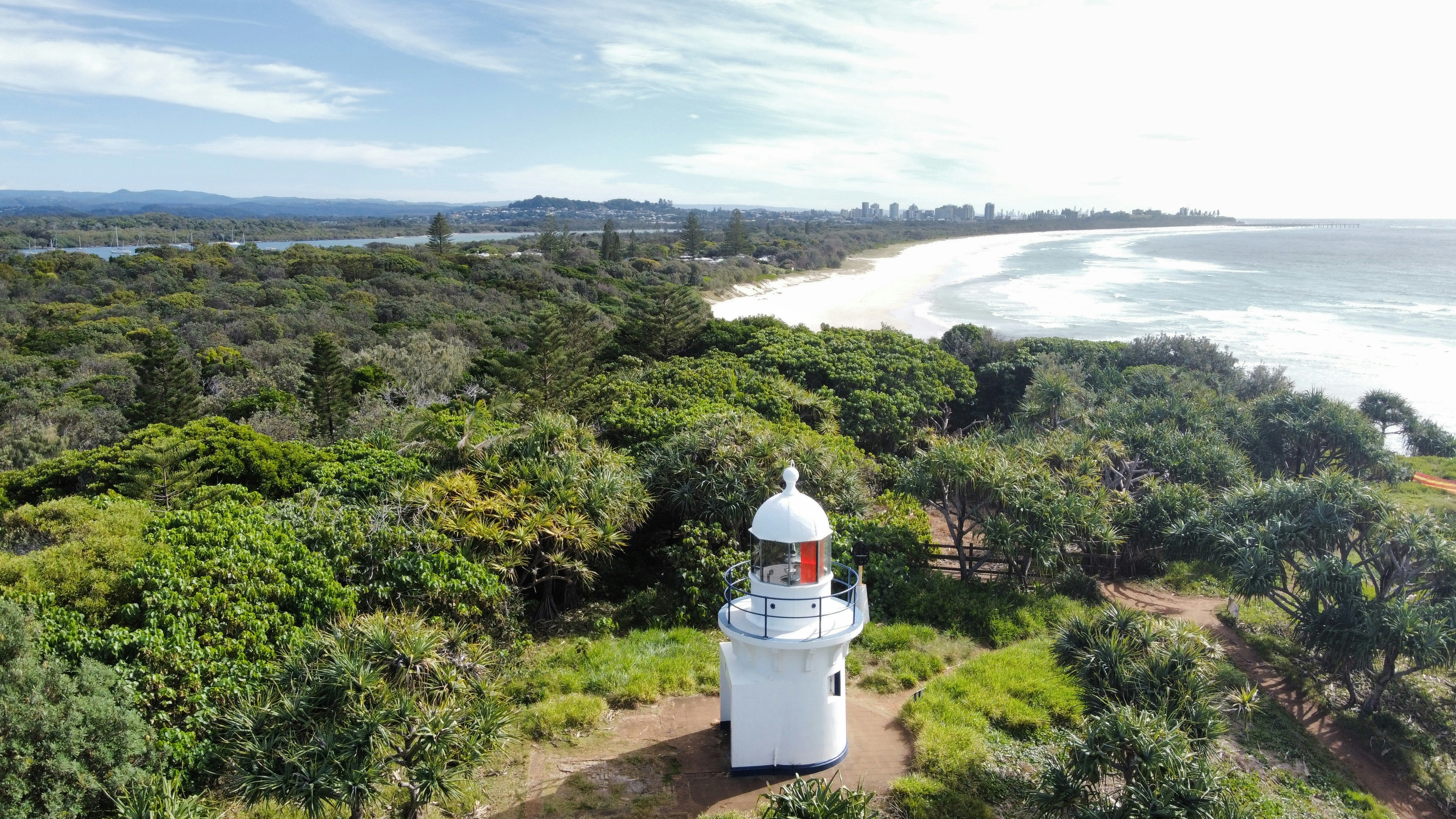 an aerial view of a lighthouse in the middle of a forest