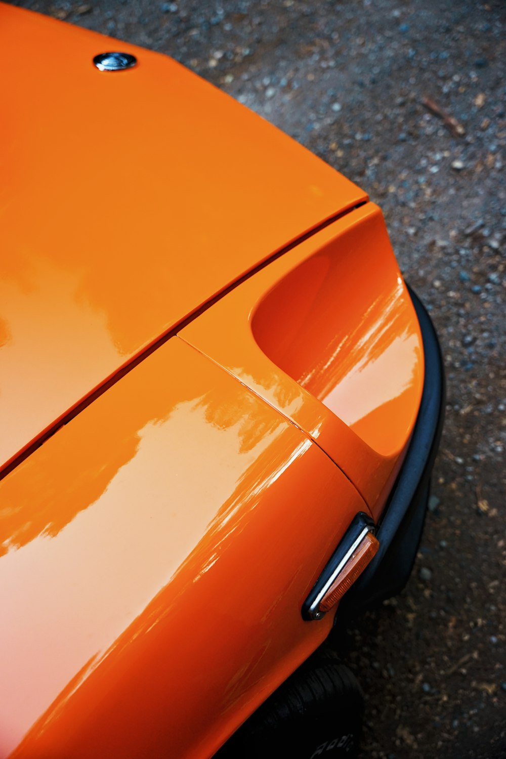 a close up of an orange sports car