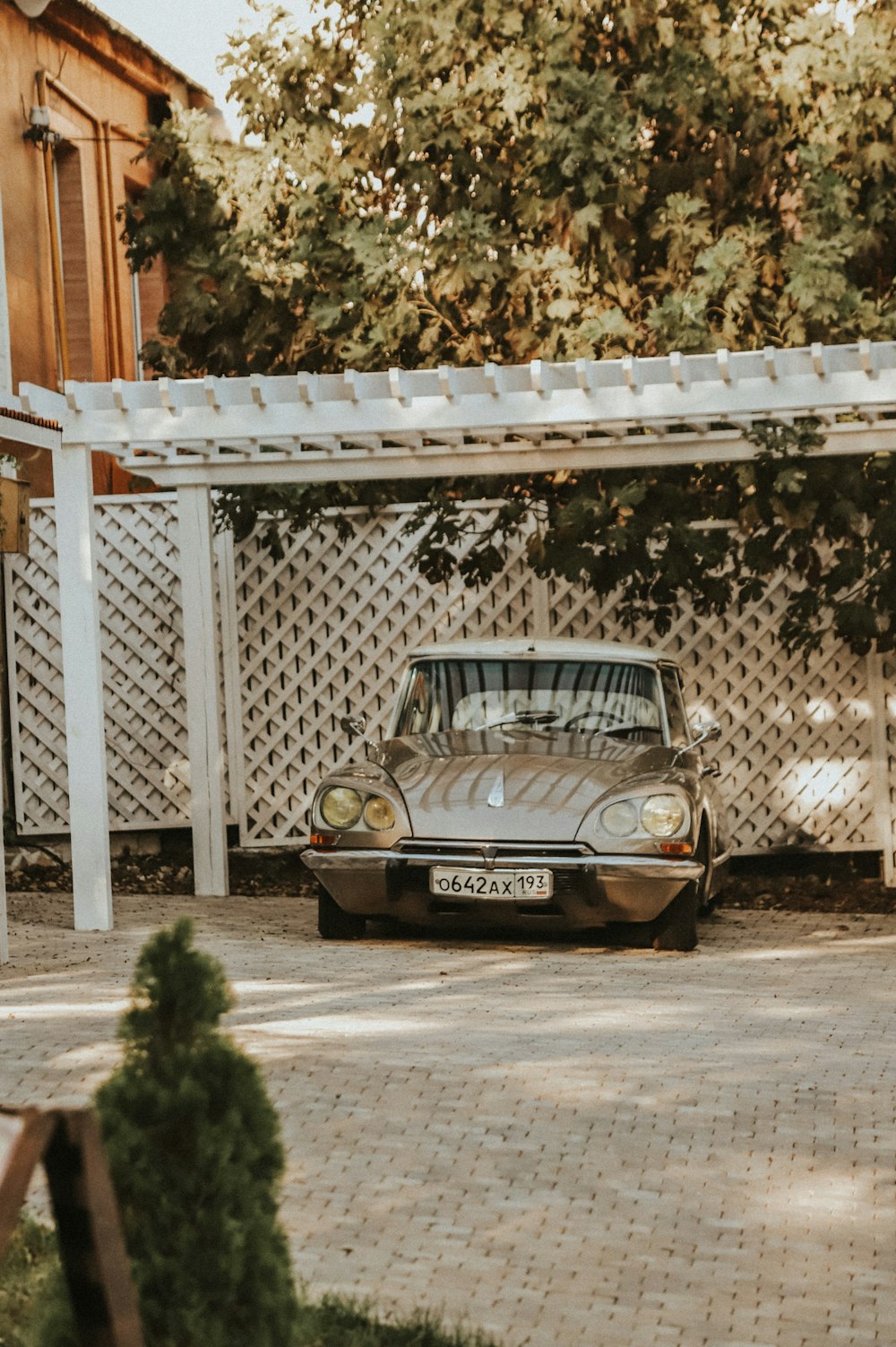 a car parked in front of a white fence