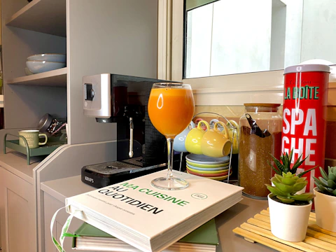 A stylish kitchen nook with decorative jars, plants, and neatly arranged cookware inviting creativity.