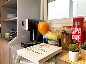 A cozy kitchen corner with a steaming cup of coffee and a plate of homemade pasta.