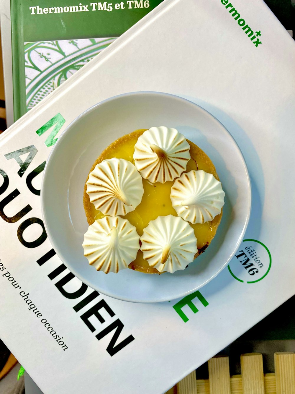 a plate of food sitting on top of a book