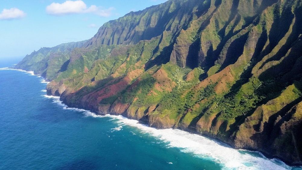 an aerial view of the ocean and mountains