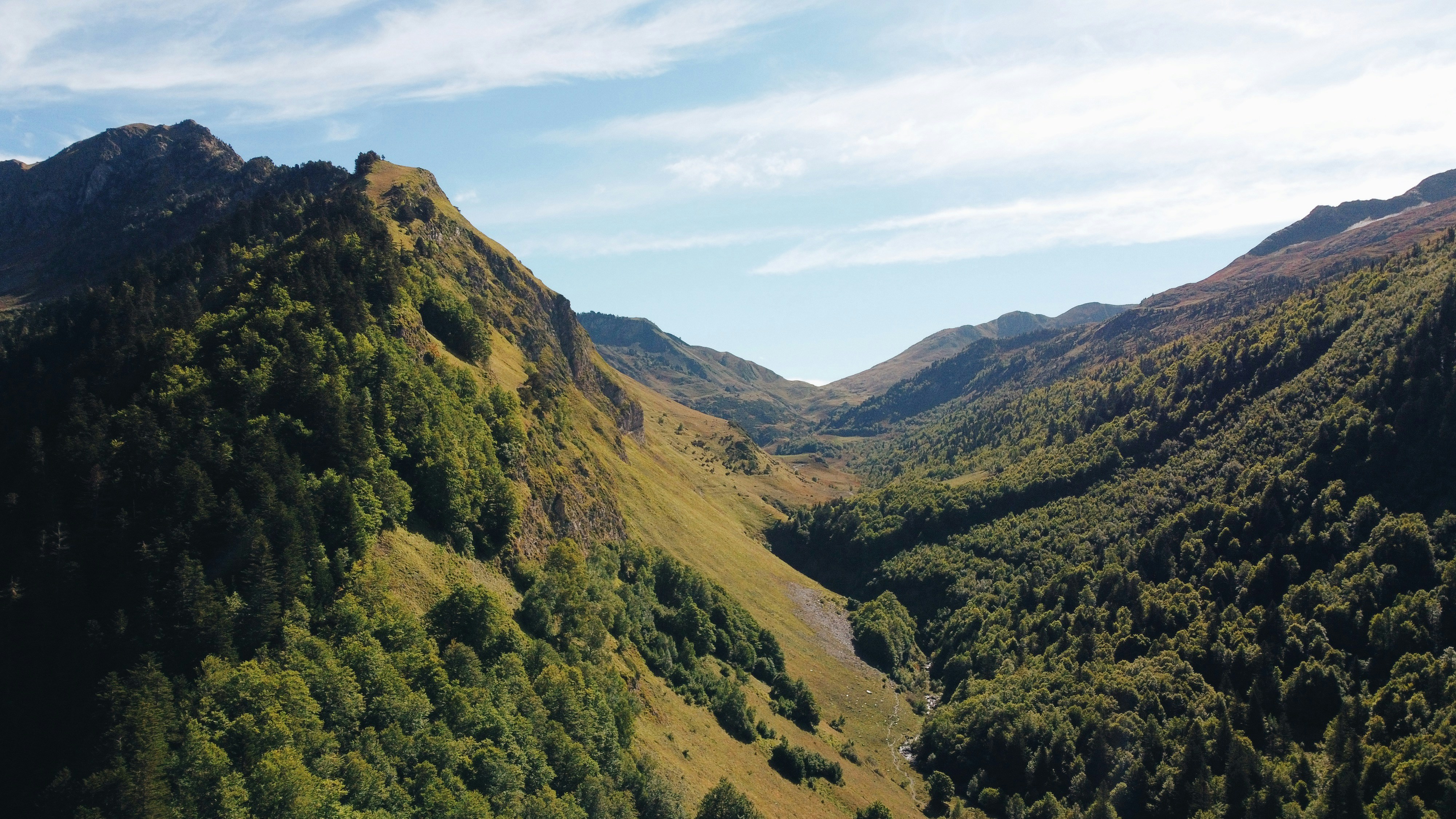 a view of a valley surrounded by mountains