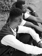 a couple of men sitting next to each other