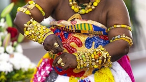a woman dressed in a colorful costume and jewelry