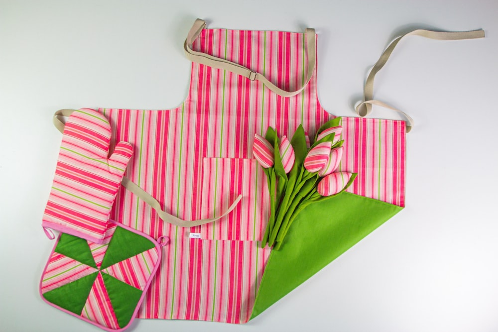 a pink and white striped bag with flowers on it