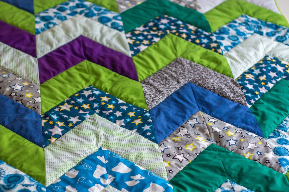 a close up of a quilt on a bed