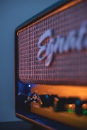 a close up of a blue amp with a logo on it