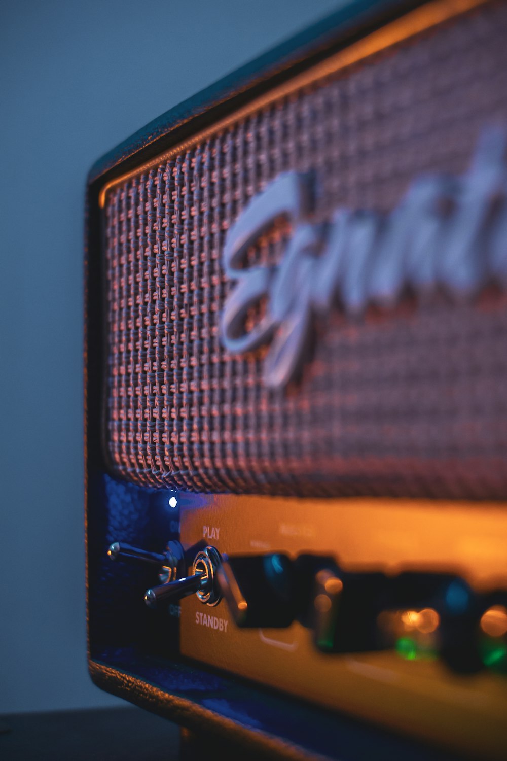 a close up of a blue amp with a logo on it