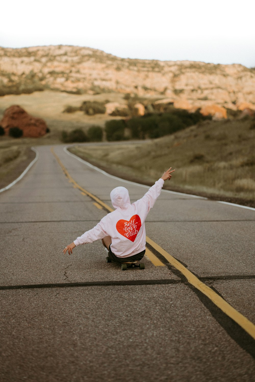 a person riding a skateboard down a road