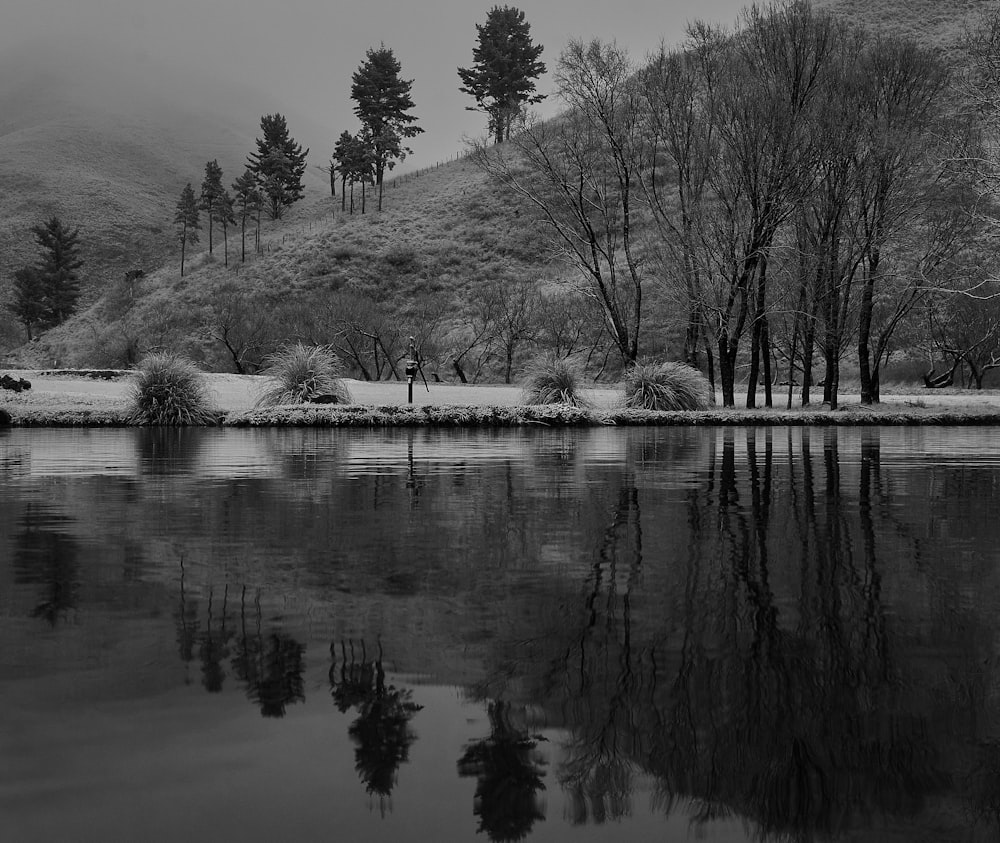 a black and white photo of a mountain lake