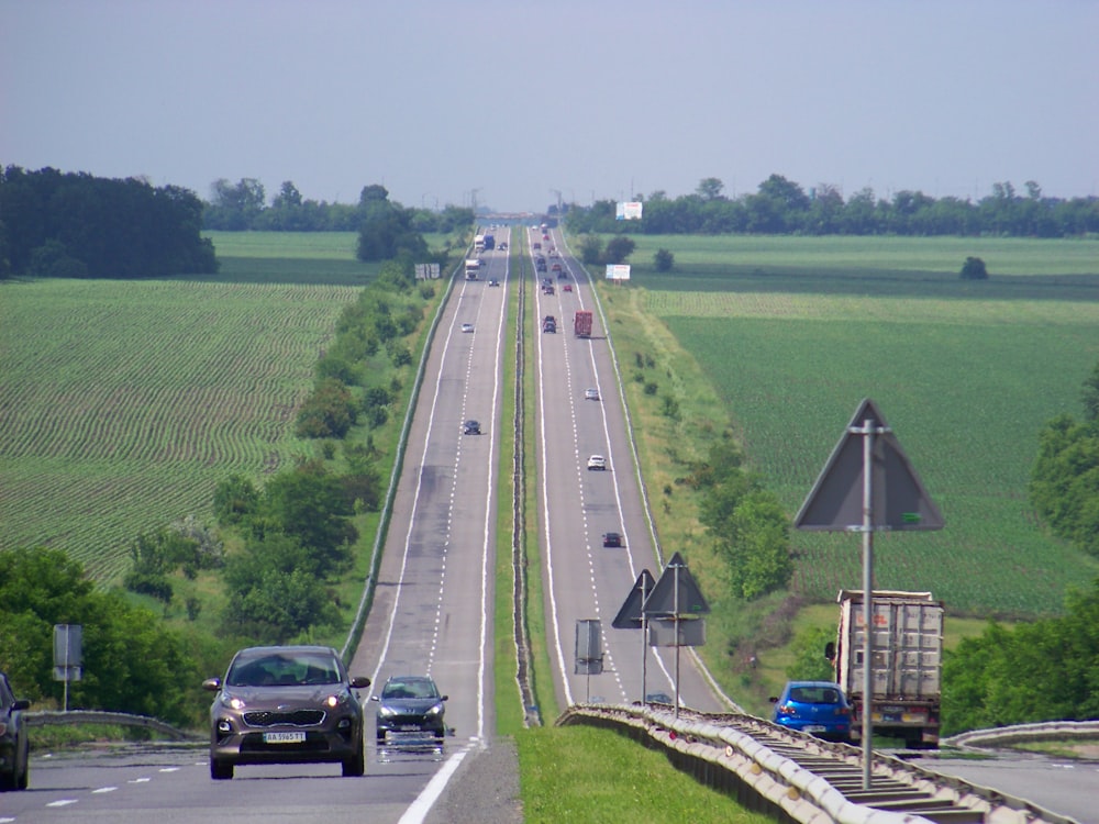 a long highway with cars driving down it