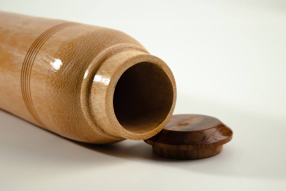 a close up of a wooden object on a white surface