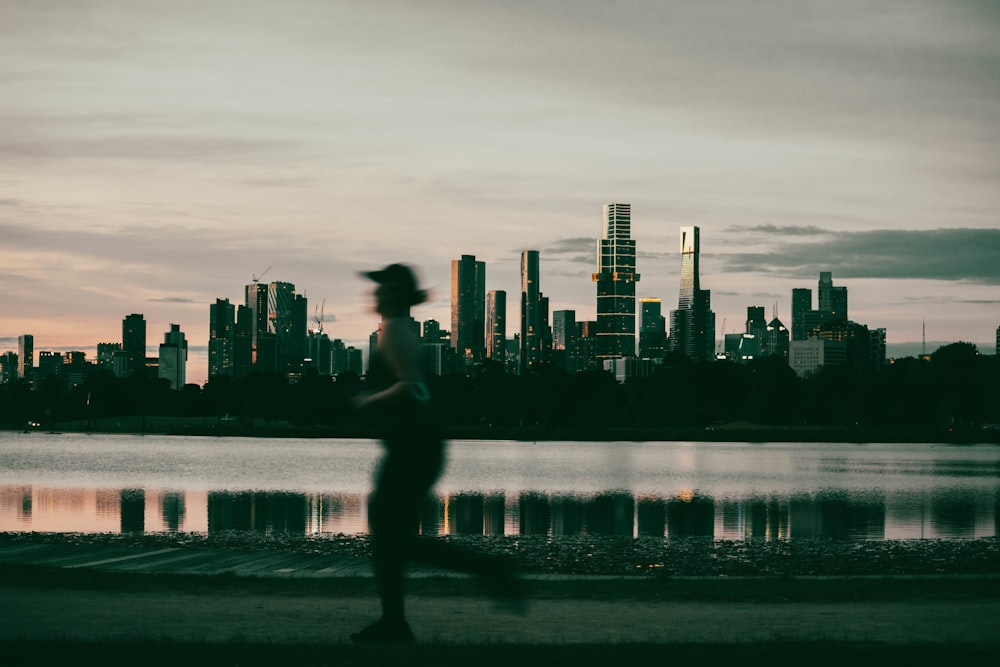 a man running in front of a city skyline