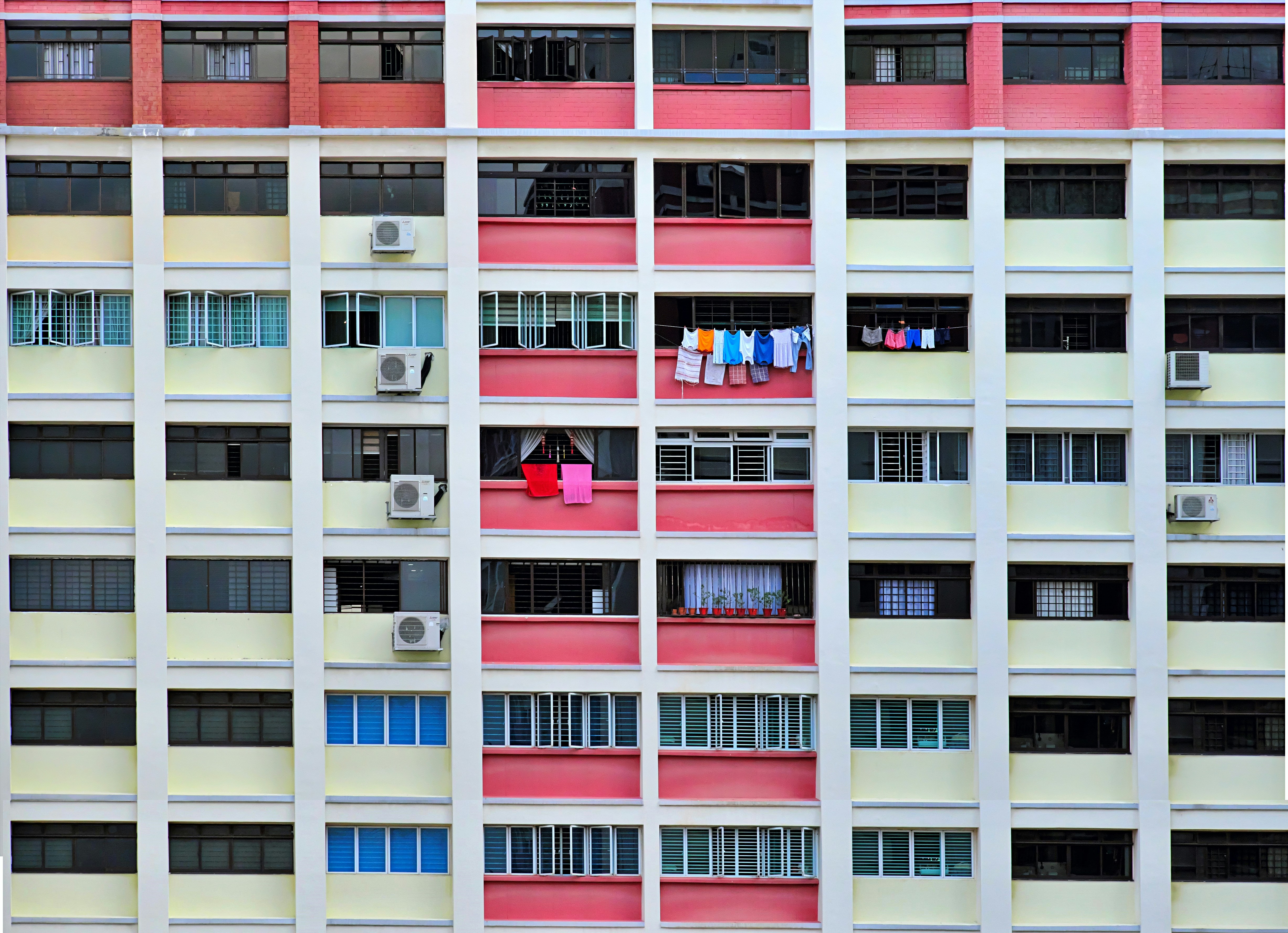 a multicolored building with clothes hanging out of the windows