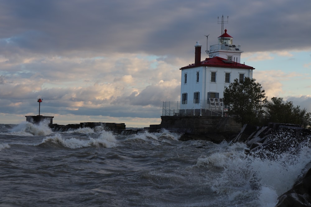 a light house sitting on top of a cliff next to the ocean