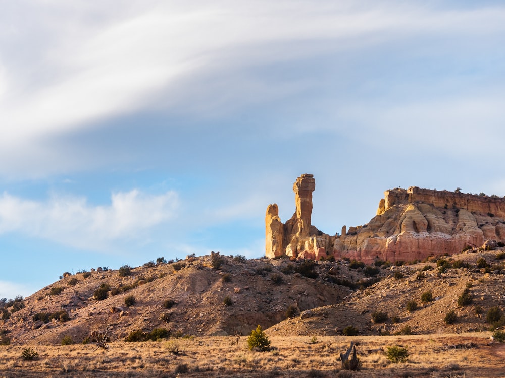 a large rock formation in the middle of a desert