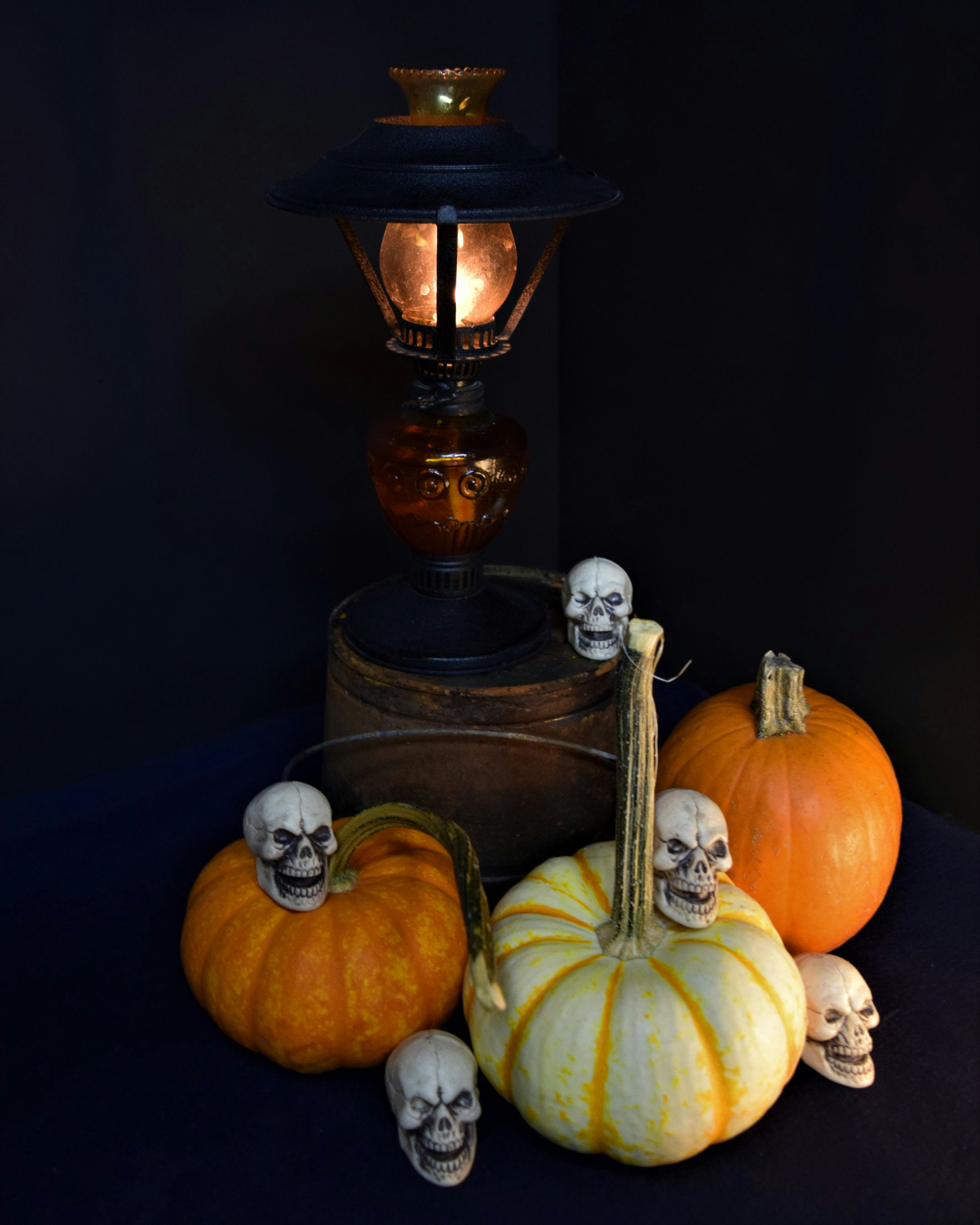 a table topped with pumpkins and skulls