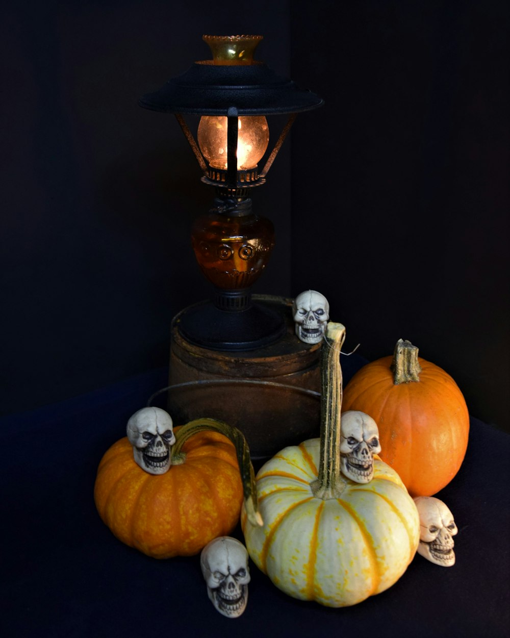 a table topped with pumpkins and skulls