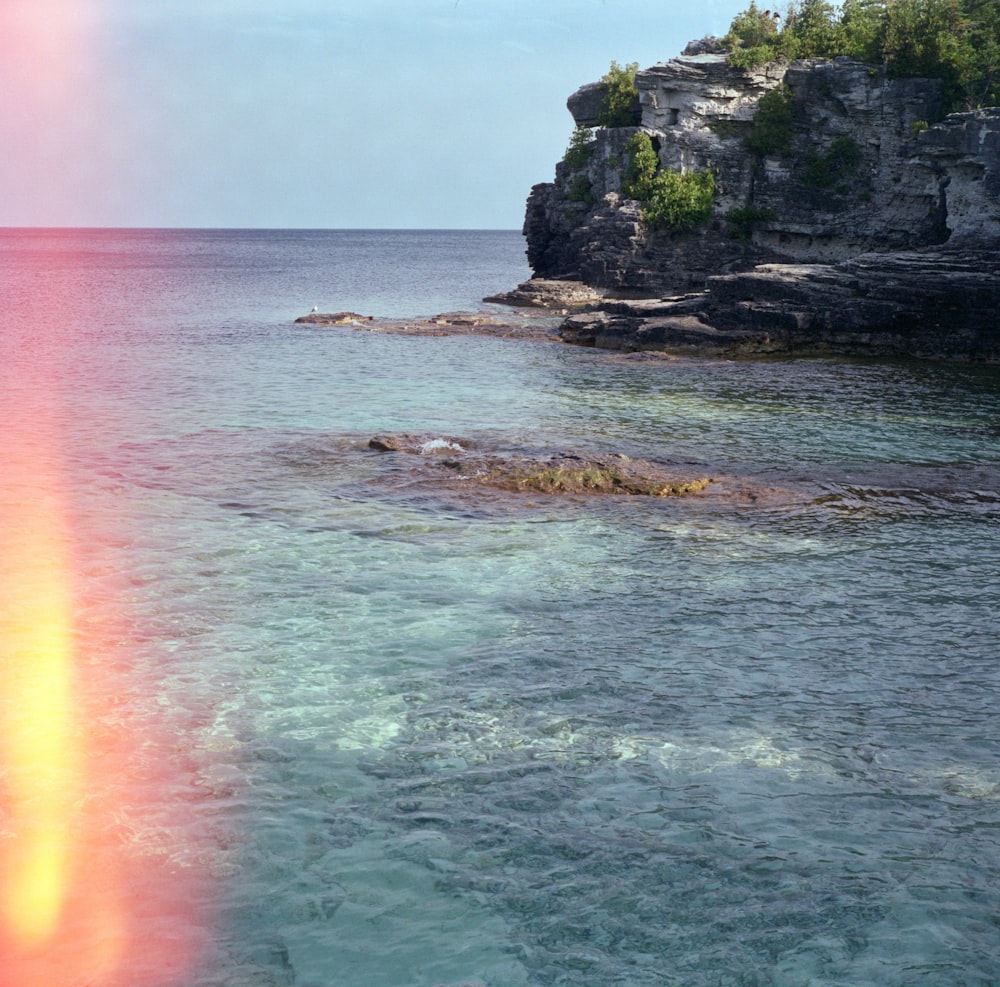 a red and yellow beam is in the middle of a body of water