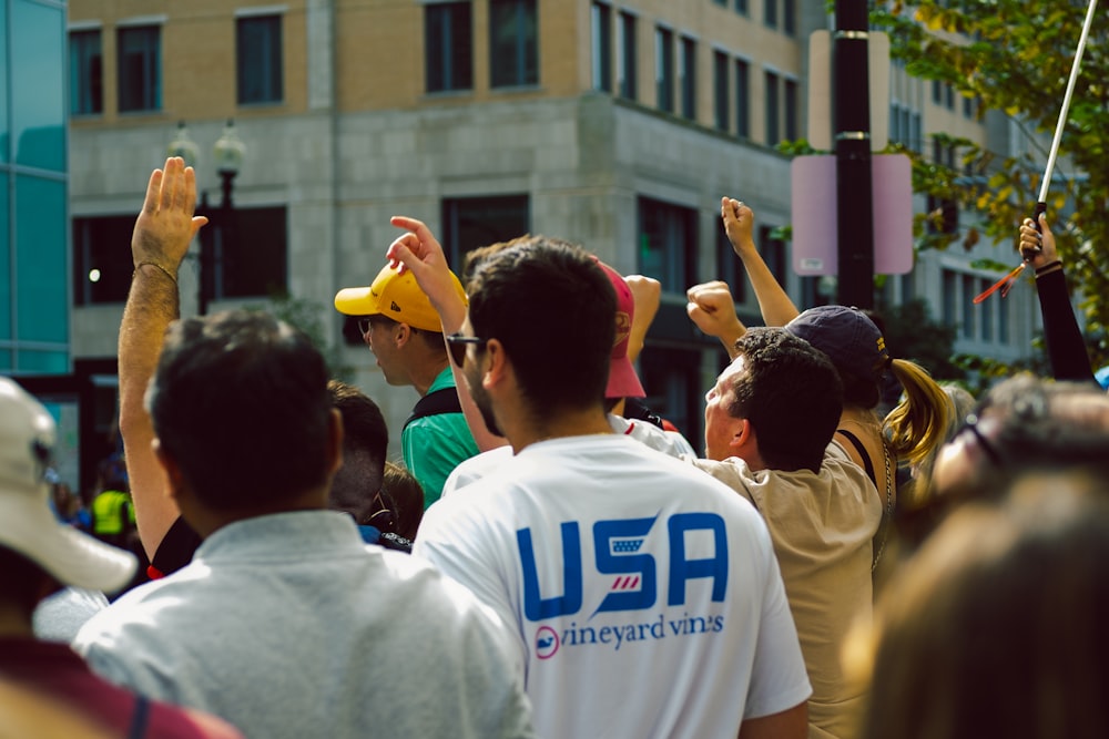 a crowd of people standing around each other