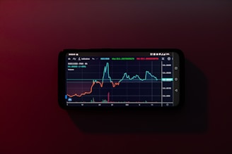 a cell phone displaying a stock chart on a red background