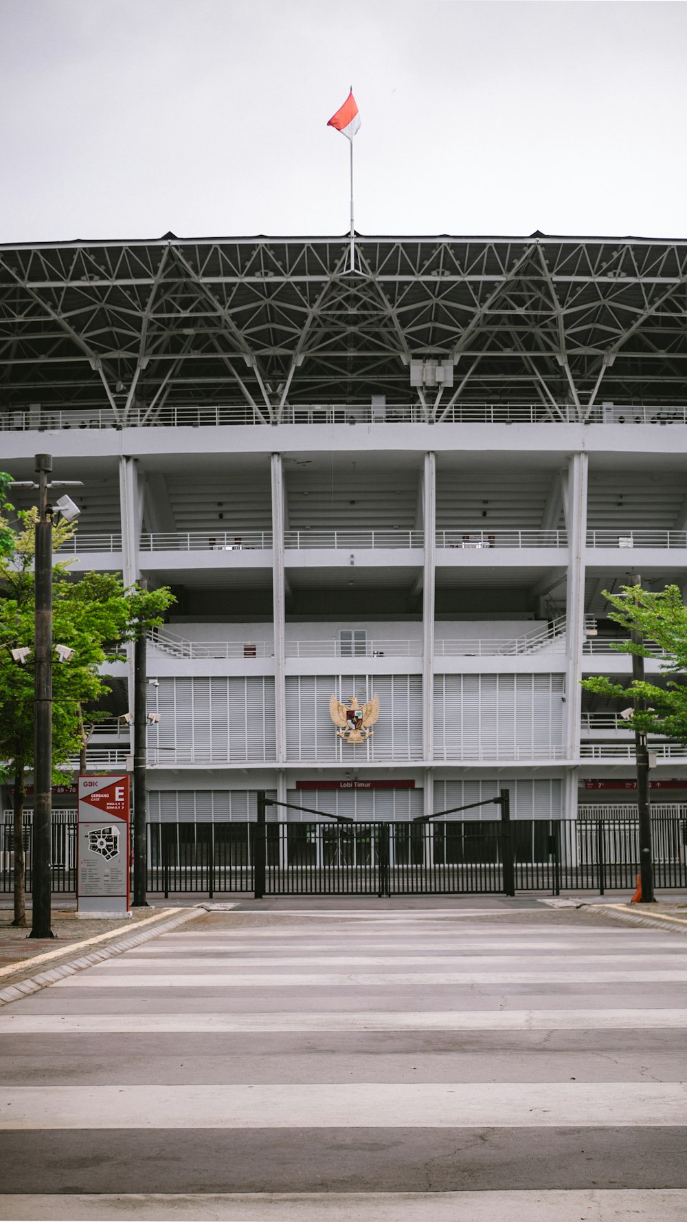 an empty parking lot in front of a large building