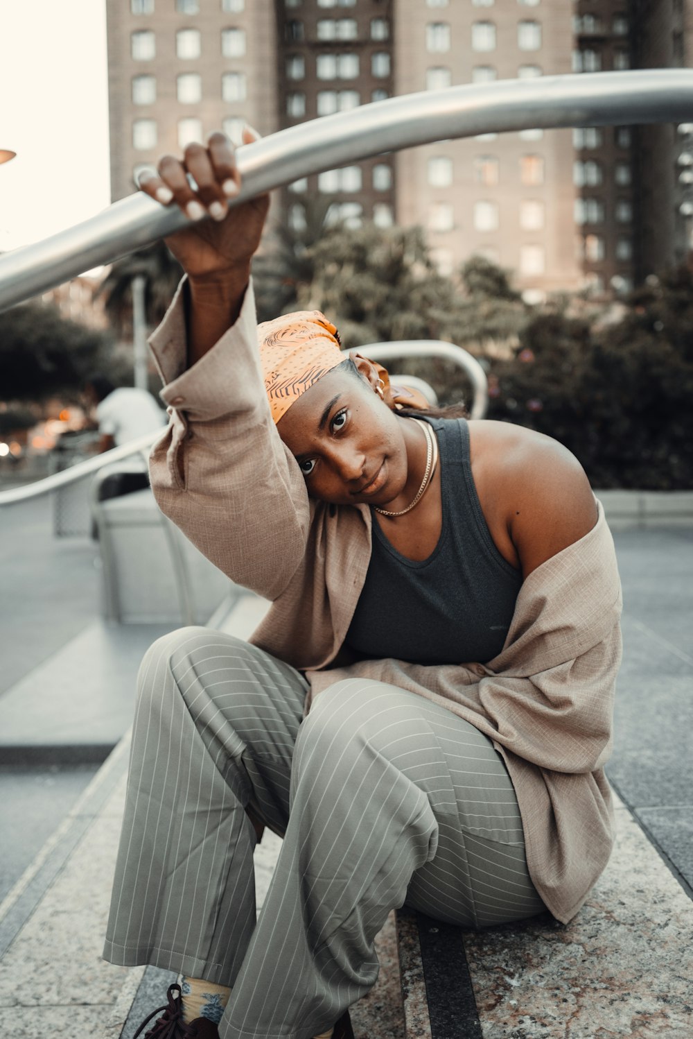 a woman sitting on a bench holding a skateboard