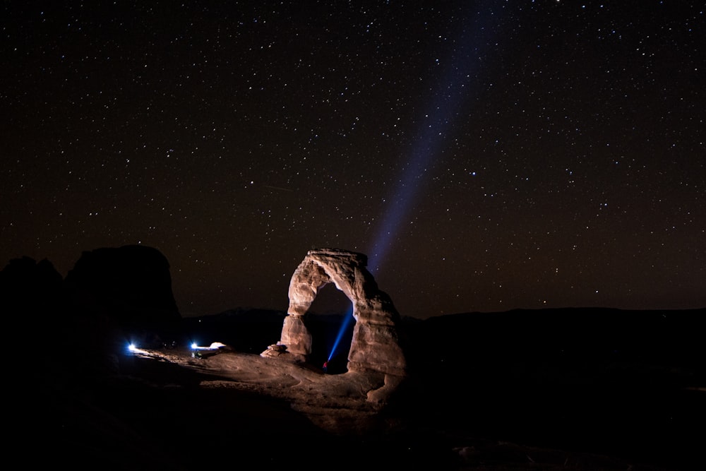 a rock formation with a light beam in the middle of it