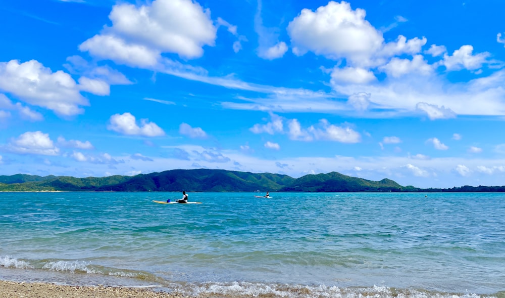 a man riding a surfboard on top of a body of water