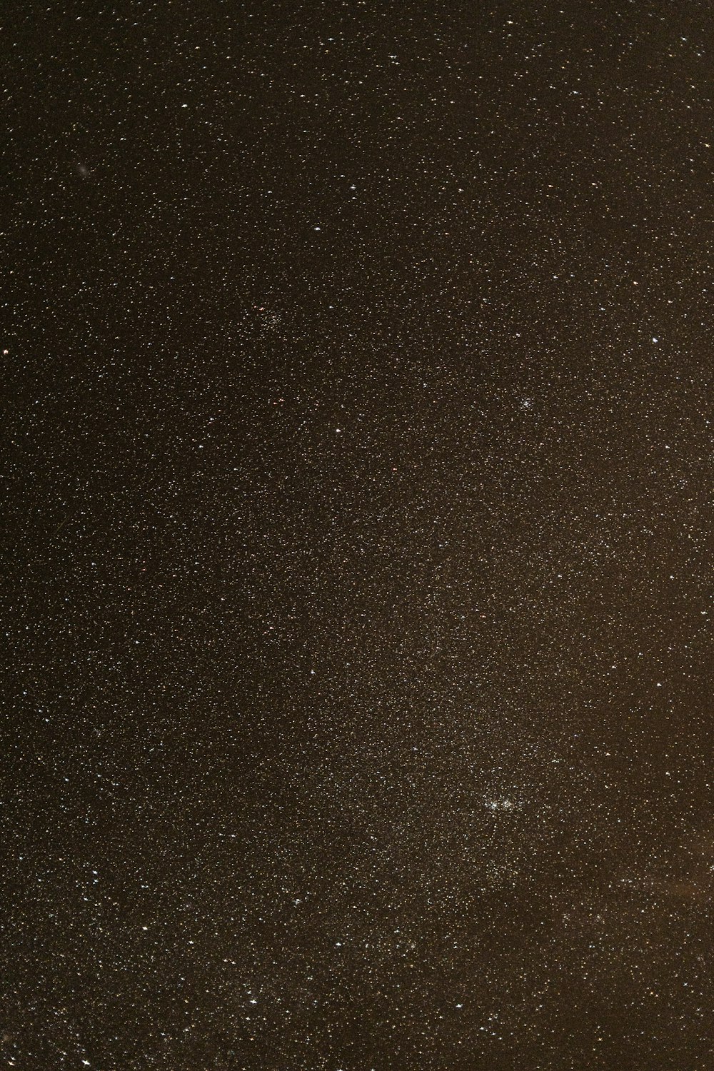 a night sky with stars and a plane in the foreground