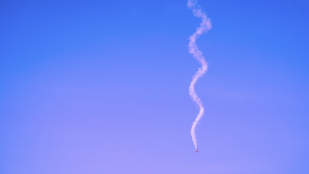 a contrail is flying in the sky