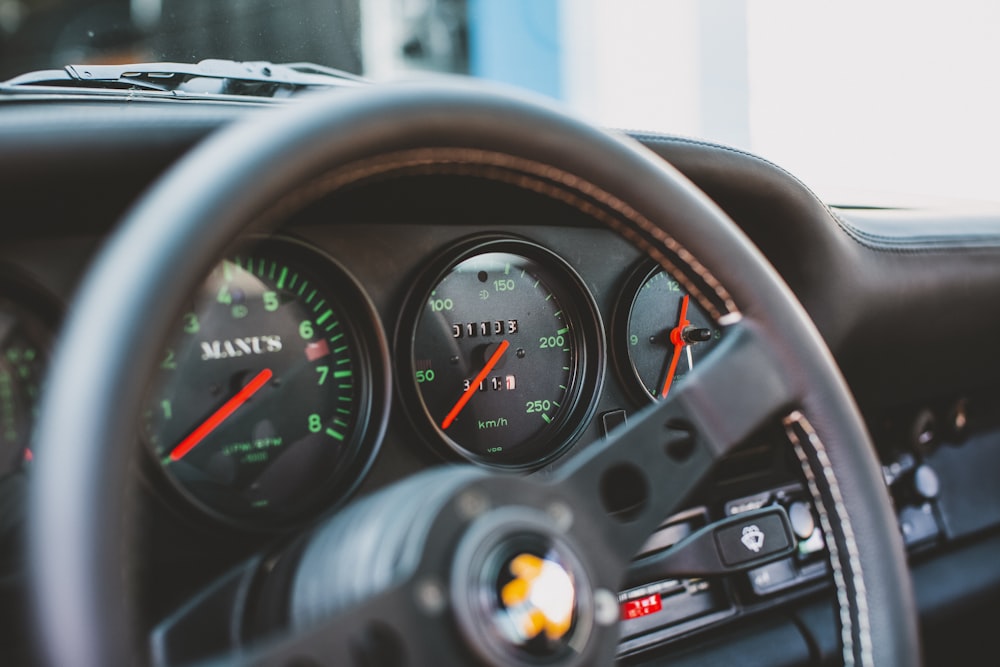 a close up of a steering wheel and dashboard of a car