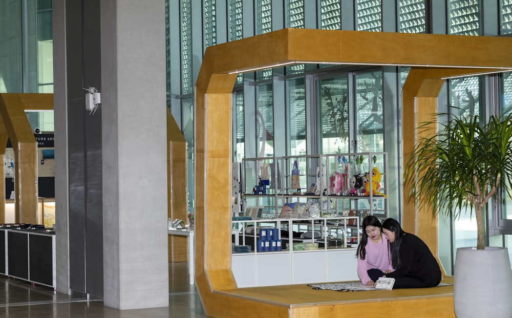 a woman sitting on a bench in a building