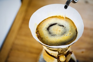 a cup of coffee is being filled with liquid