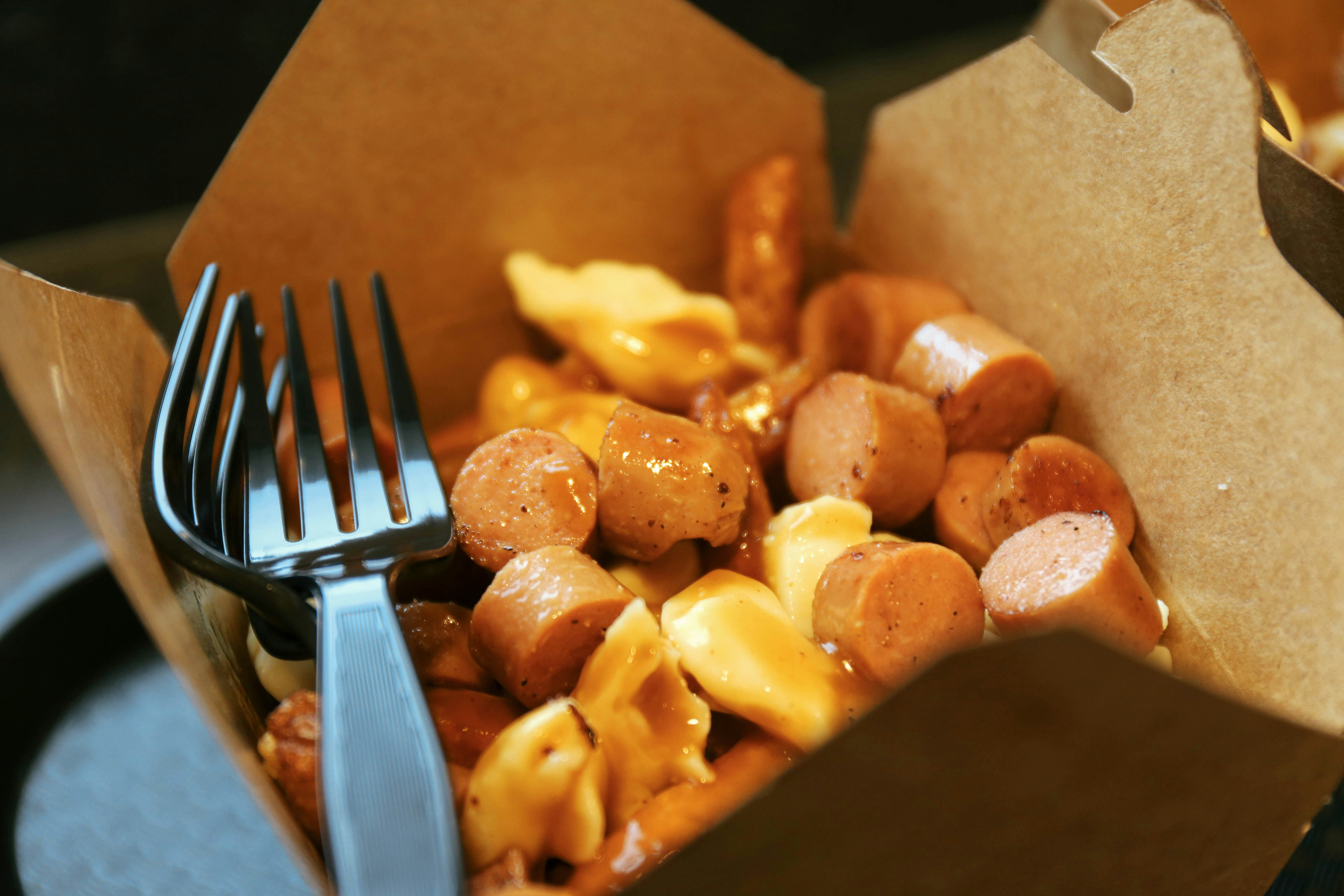Fork in a box of sausage and pasta